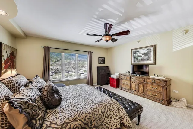 a bed room with a bed dresser and a window