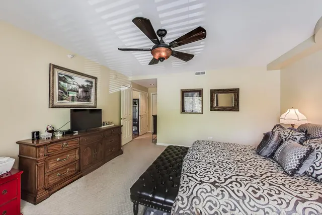 a bedroom that has a bed and a chandelier