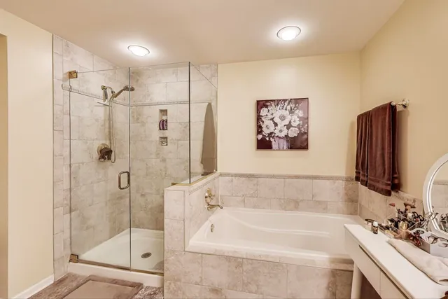 a bathroom with a bathtub a shower and a sink