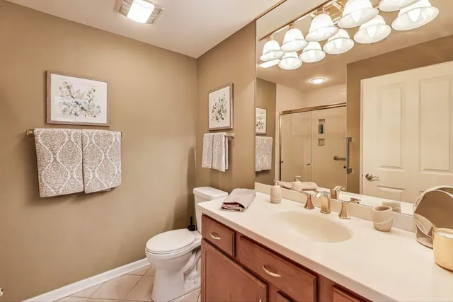 a bathroom with a sink vanity mirror and toilet