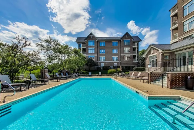 a view of a house with swimming pool and sitting area