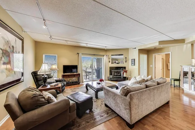 a living room with furniture flat screen tv and a fireplace