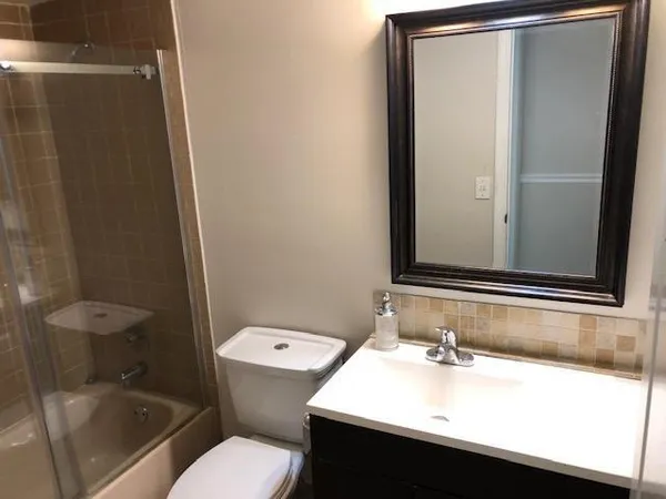 a bathroom with a sink toilet and shower