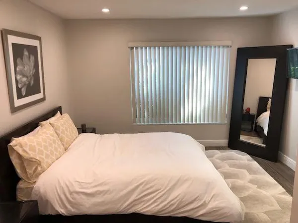 a bedroom with a bed and a mirror
