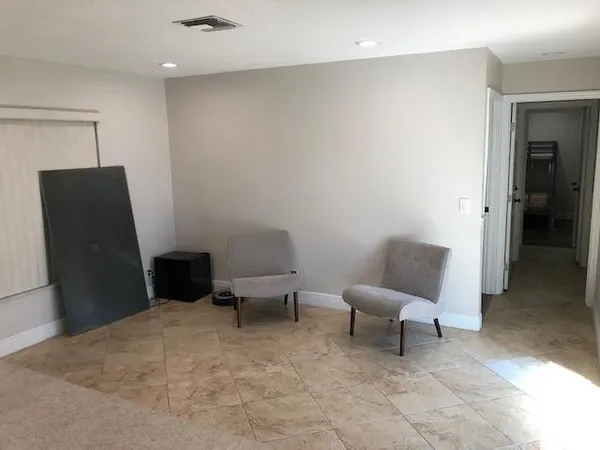 a living room with furniture and a chair