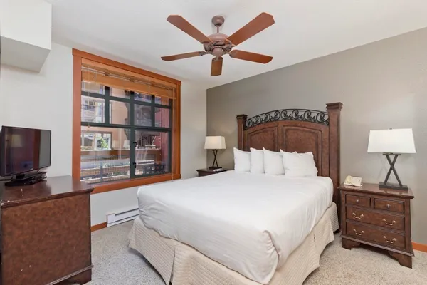 a bedroom with a bed and a flat screen tv