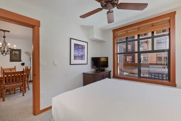 a bedroom with a bed and a flat screen tv