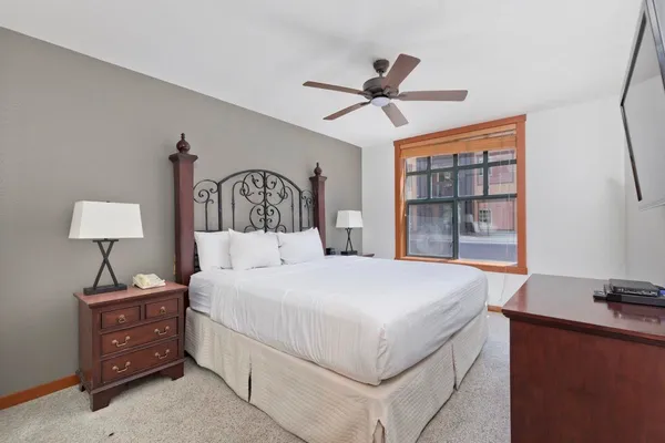 a bedroom with a large bed and a window