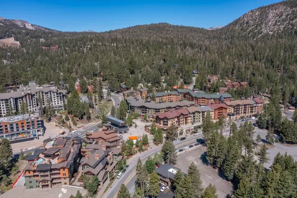 an aerial view of a swimming pool patio and outdoor seating