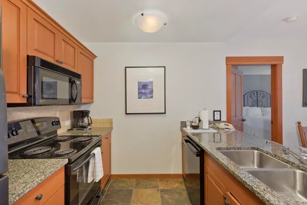 a kitchen that has a sink and a stove