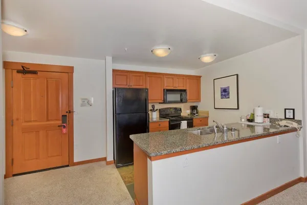 a kitchen with granite countertop cabinets and stainless steel appliances