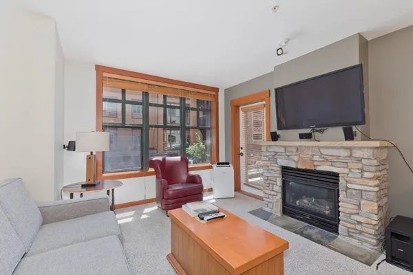 a living room with furniture a flat screen tv and a fireplace