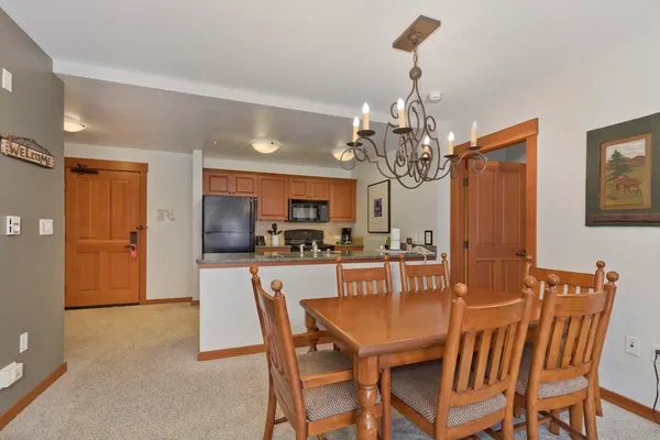 a view of a dining room with furniture and chandelier