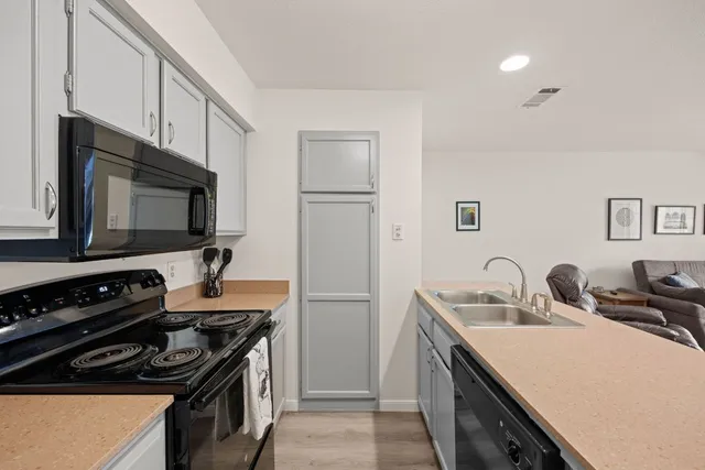 a kitchen with a sink stove and microwave