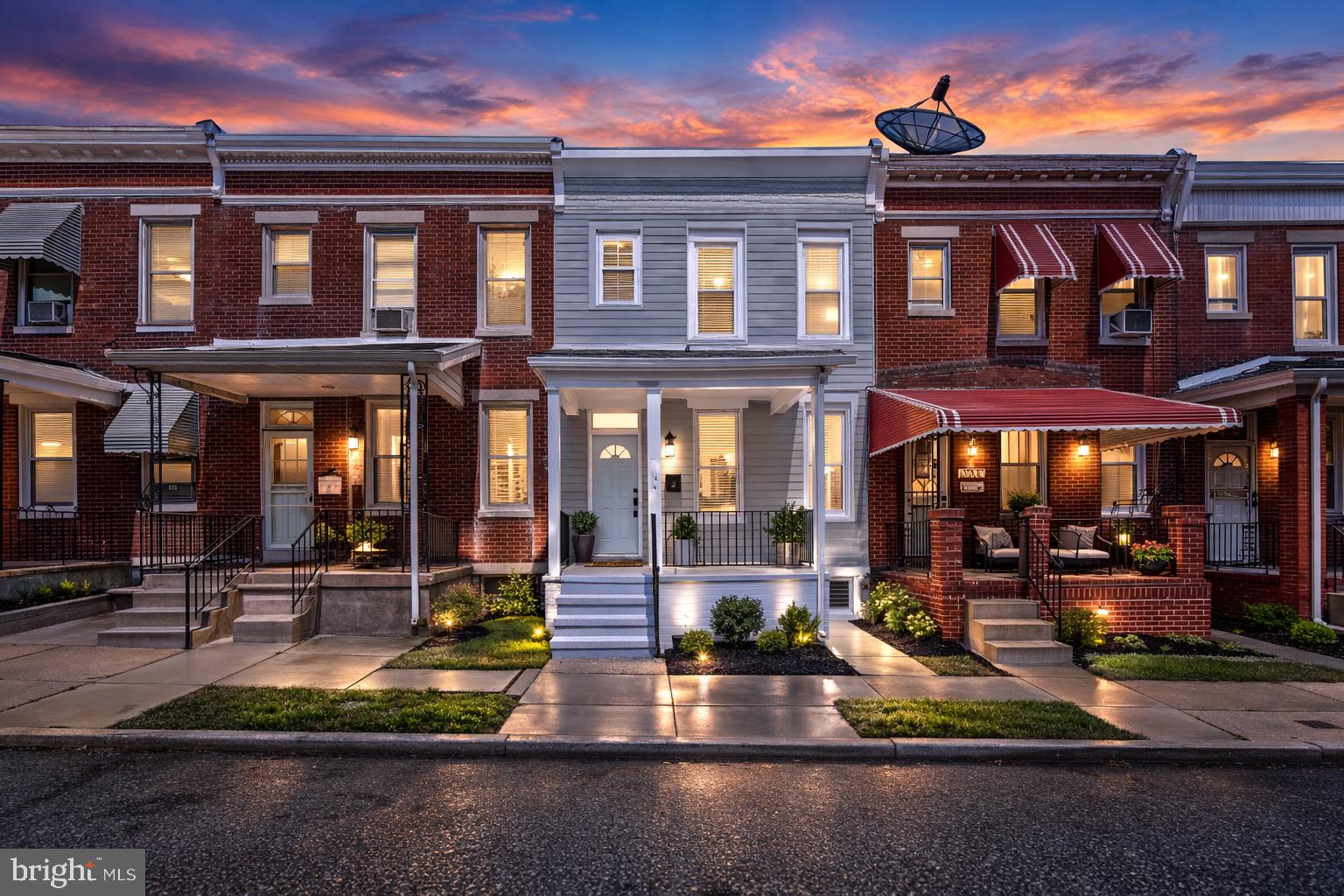 1724 East 25th Street Baltimore, MD 21213 - Photo 1 of 10 front view of a brick building with a small yard