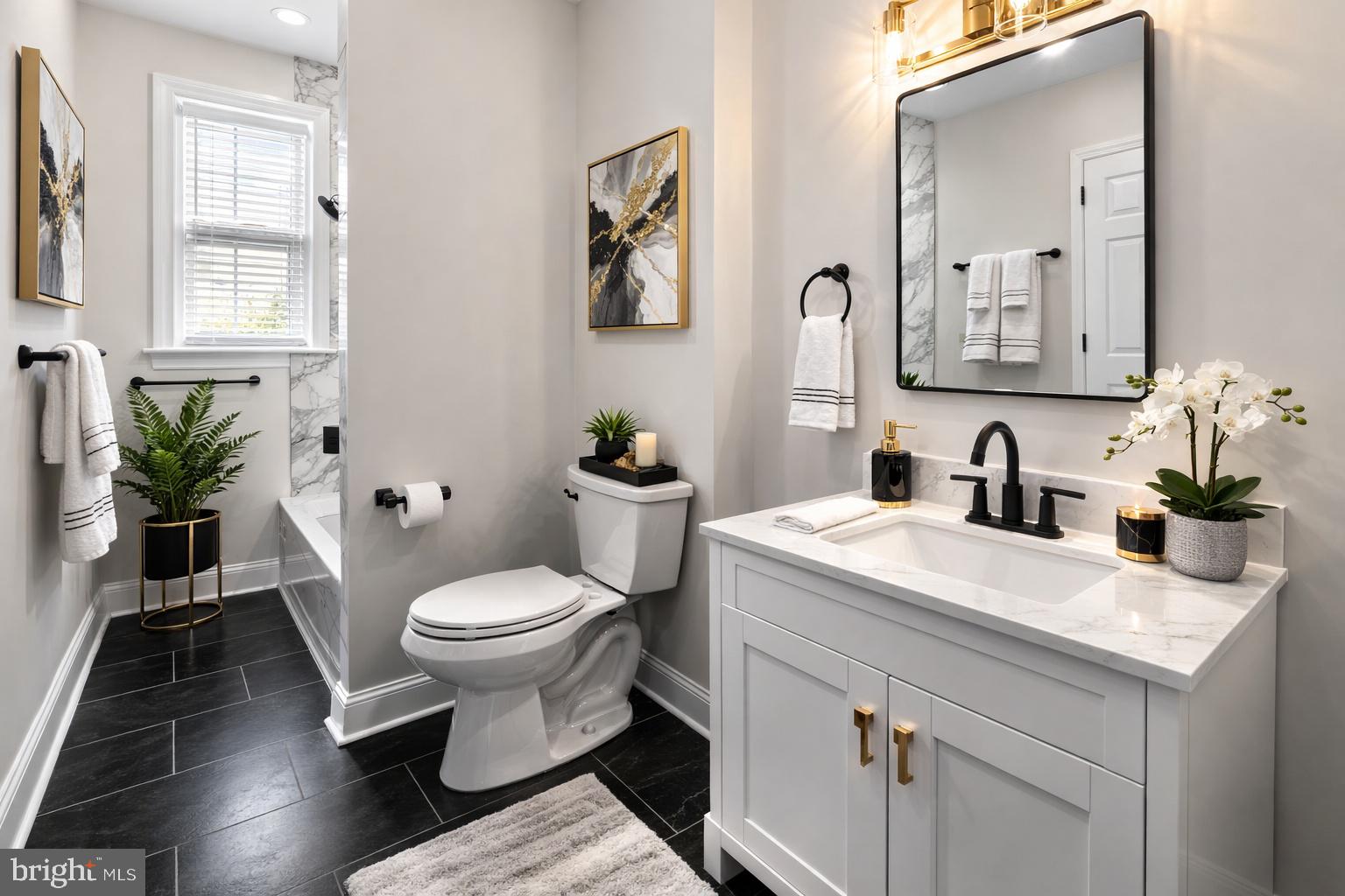1724 East 25th Street Baltimore, MD 21213 - Photo 3 of 10 a bathroom with a toilet sink and mirror