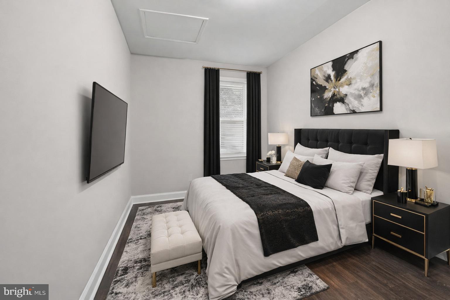 1724 East 25th Street Baltimore, MD 21213 - Photo 7 of 10 a bedroom with a bed and a flat screen tv