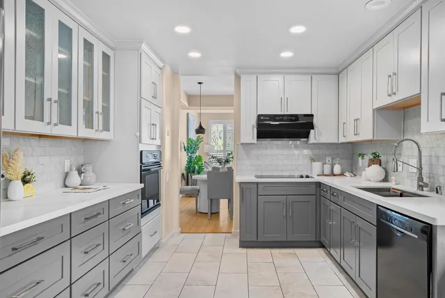 a kitchen with a sink a stove and cabinets
