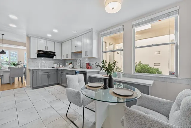 a kitchen with granite countertop a sink and white appliances
