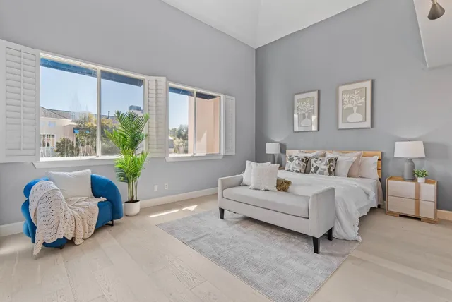 a spacious bedroom with a bed and a couch