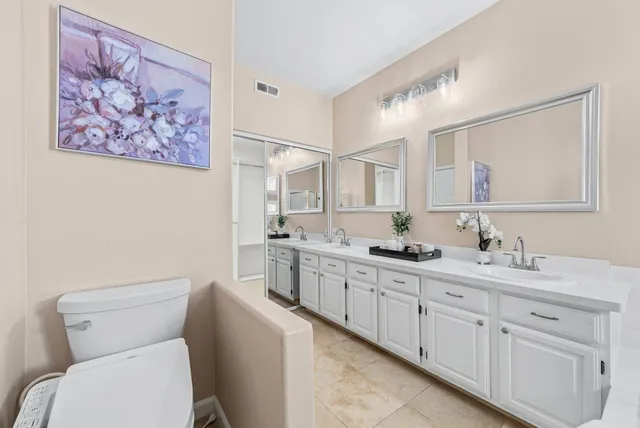 a bathroom with a toilet sink and mirror