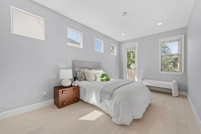 a bedroom with a bed and a lamp