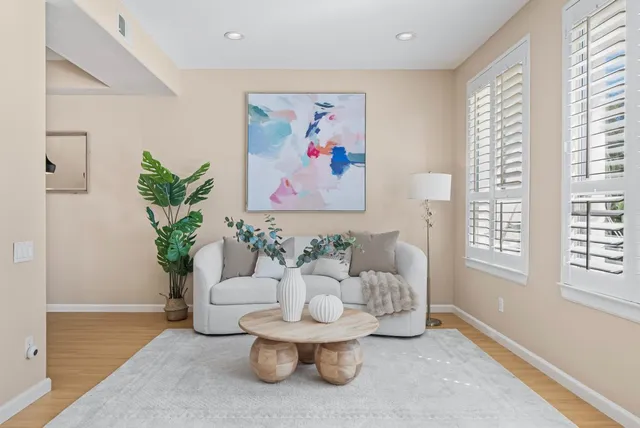 a living room with furniture and a potted plant
