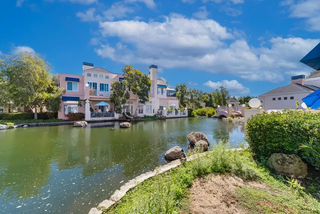 a view of a lake with a house in the background