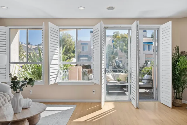 a living room with furniture and large windows