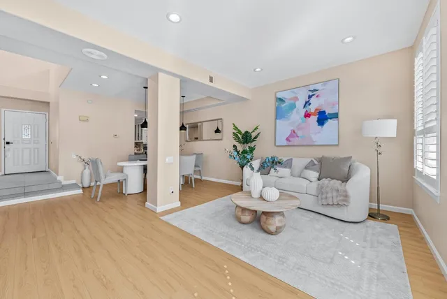 a living room with furniture and a wooden floor