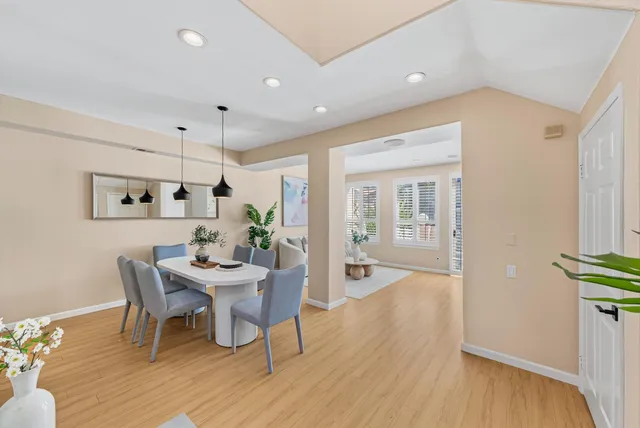 a view of a dining room with furniture and wooden floor