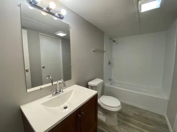 a bathroom with a sink toilet a mirror and shower