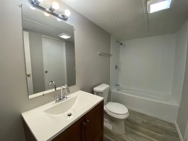 a bathroom with a sink toilet a mirror and shower