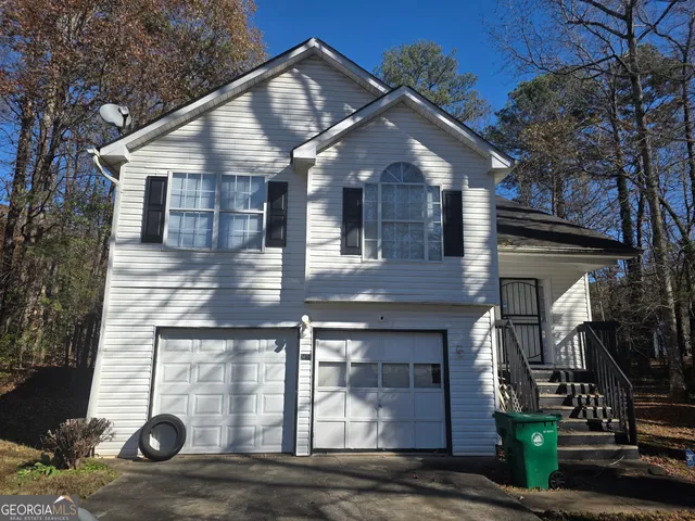 a front view of a house with garage