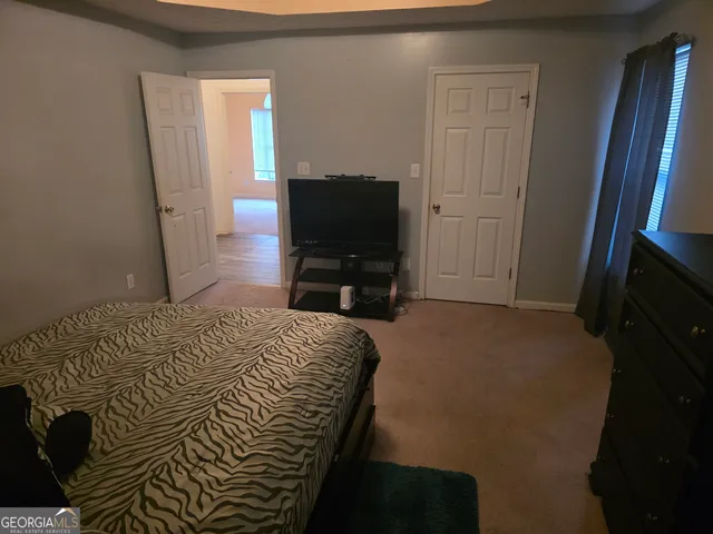 a bedroom with a bed and a television in it