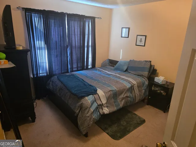 a bed sitting in a bedroom next to a wooden door