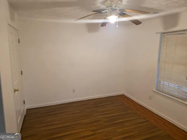 a view of a room with wooden floor