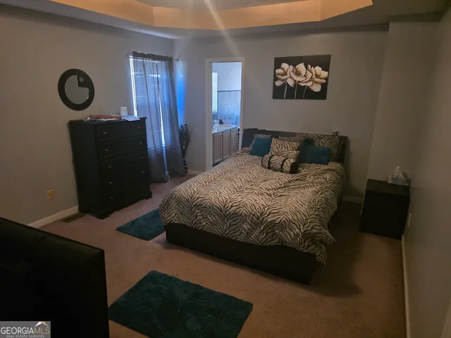 a bedroom with a bed and a wall painting