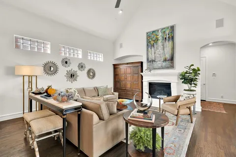 a living room with furniture a fireplace and a table