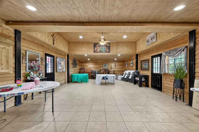 a room with lots of tables a mirror and chairs