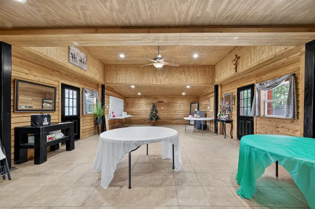 a view of a patio with table and chairs potted plants with wooden floor