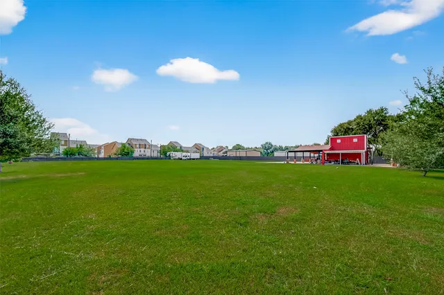 a view of green field with houses
