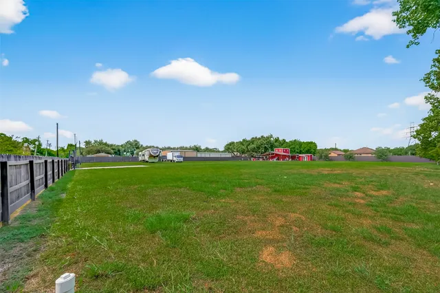a view of a house with a backyard and a garden