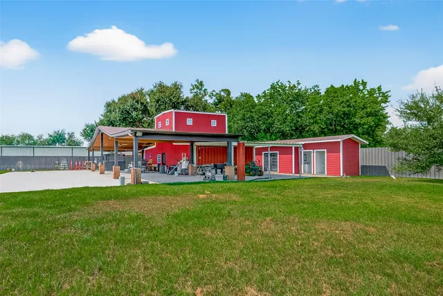 a view of a yard with a house in the background