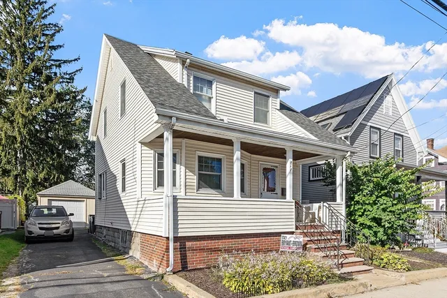 a front view of a house with a garden