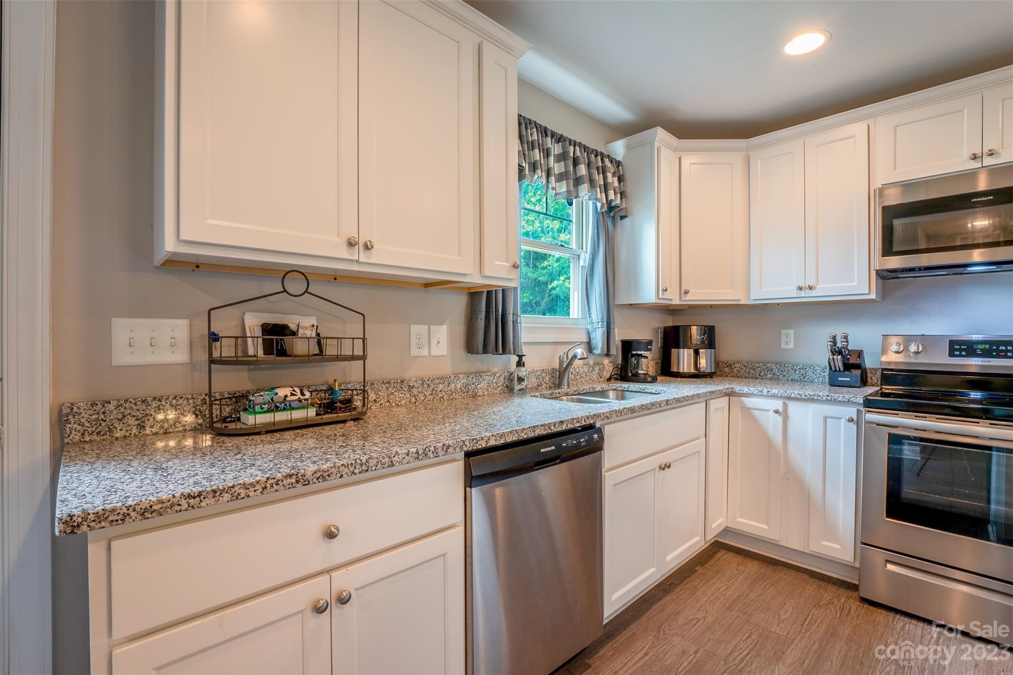 212 Old Centergrove Road Kannapolis, NC 28083 - Photo 12 of 39 a kitchen with granite countertop white cabinets white appliances and a sink