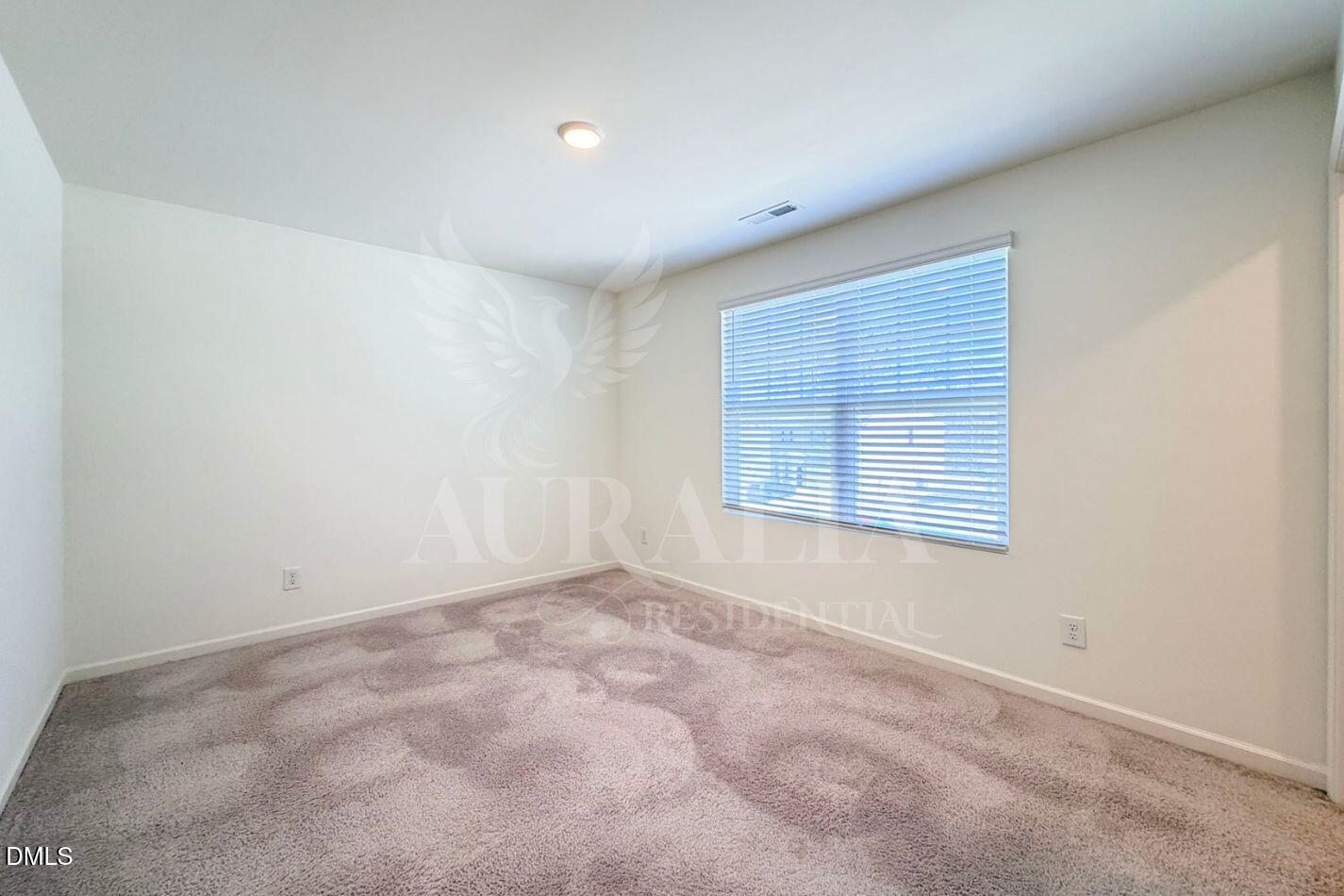 937 Berkeley Glen Road Zebulon, NC 27597 - Photo 17 of 35 an empty room with a window