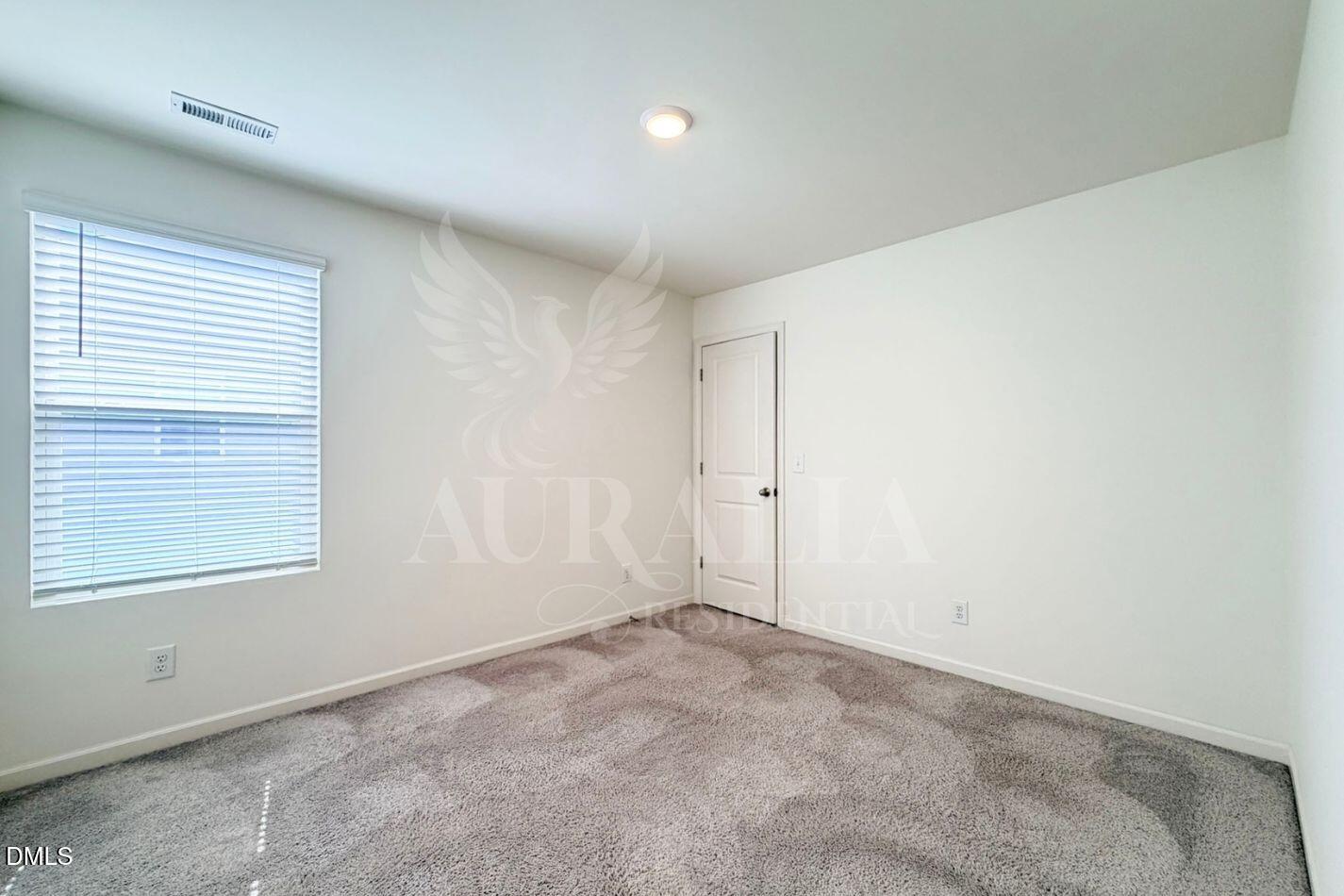 937 Berkeley Glen Road Zebulon, NC 27597 - Photo 20 of 35 an empty room with a window