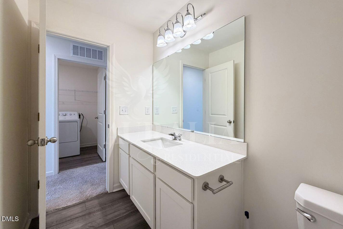 937 Berkeley Glen Road Zebulon, NC 27597 - Photo 21 of 35 a bathroom with a sink a mirror and a toilet