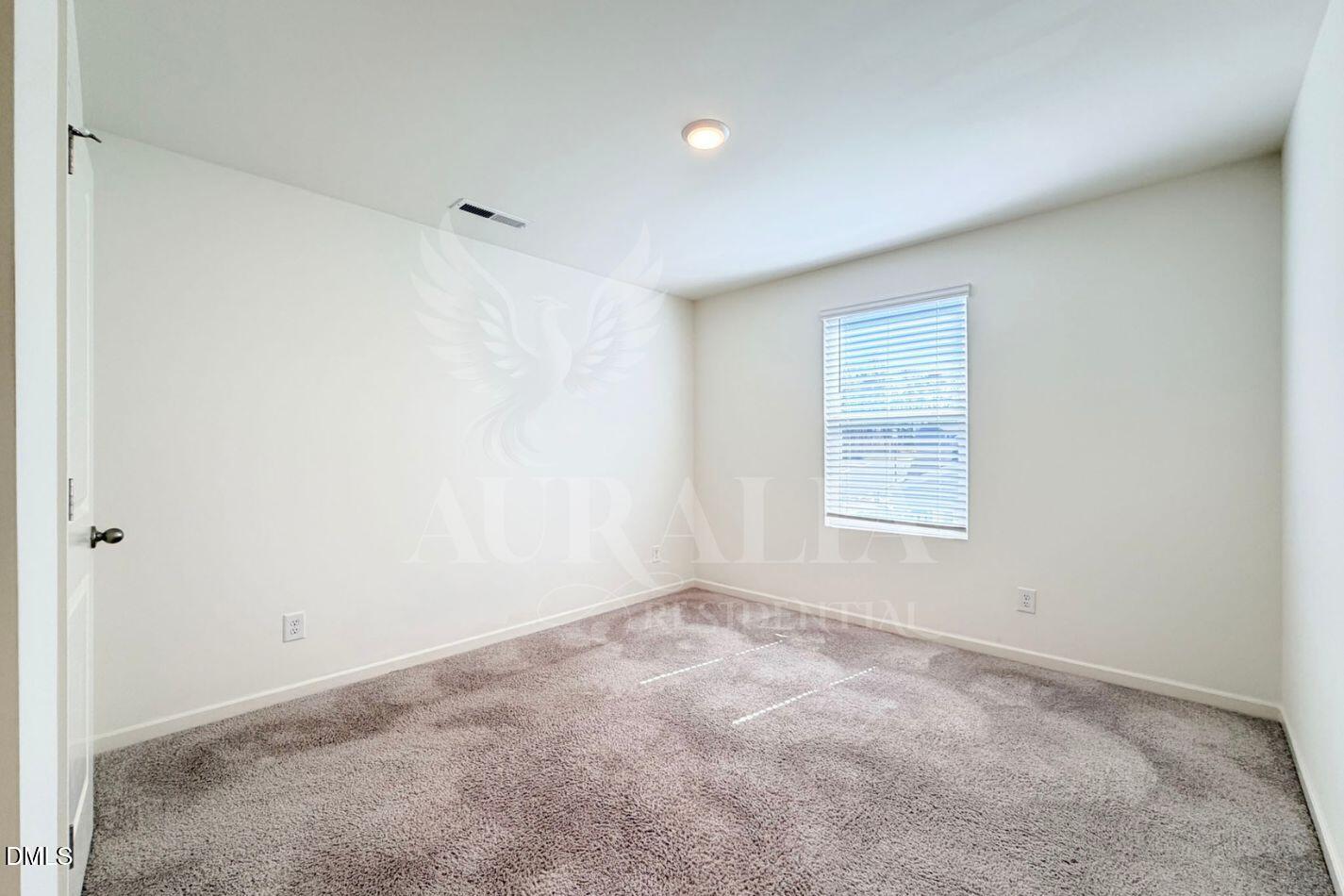 937 Berkeley Glen Road Zebulon, NC 27597 - Photo 23 of 35 a view of an empty room with a window